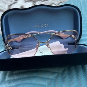 Gucci butterfly shaped sunglasses pink lenses, gold metal frame and GG logo